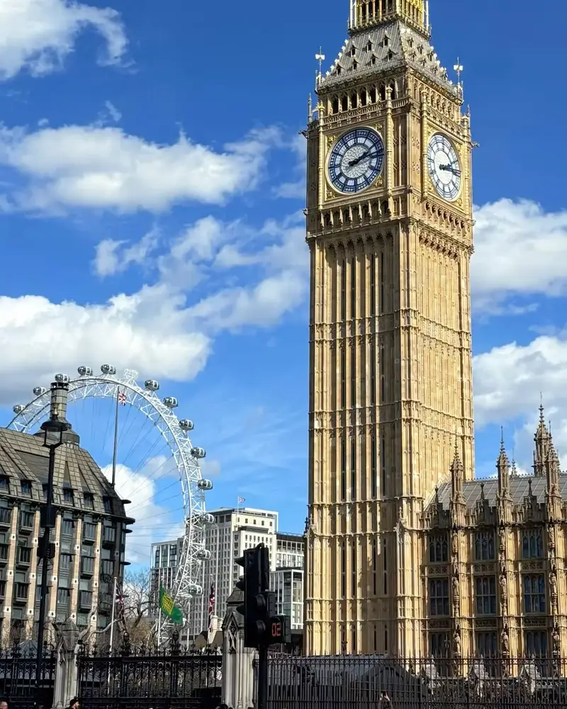 Big Ben and the London Eye under a blue sky